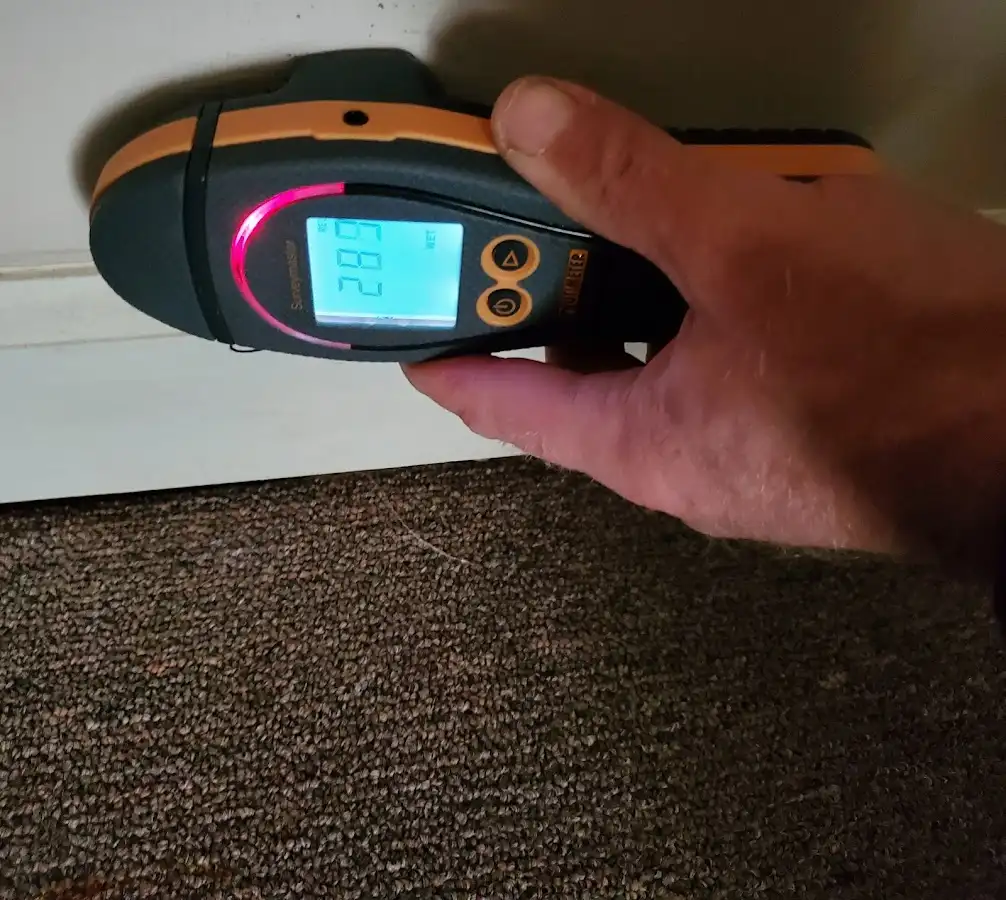Moisture detection at baseboard during Storm Damage Restoration in Riverside
